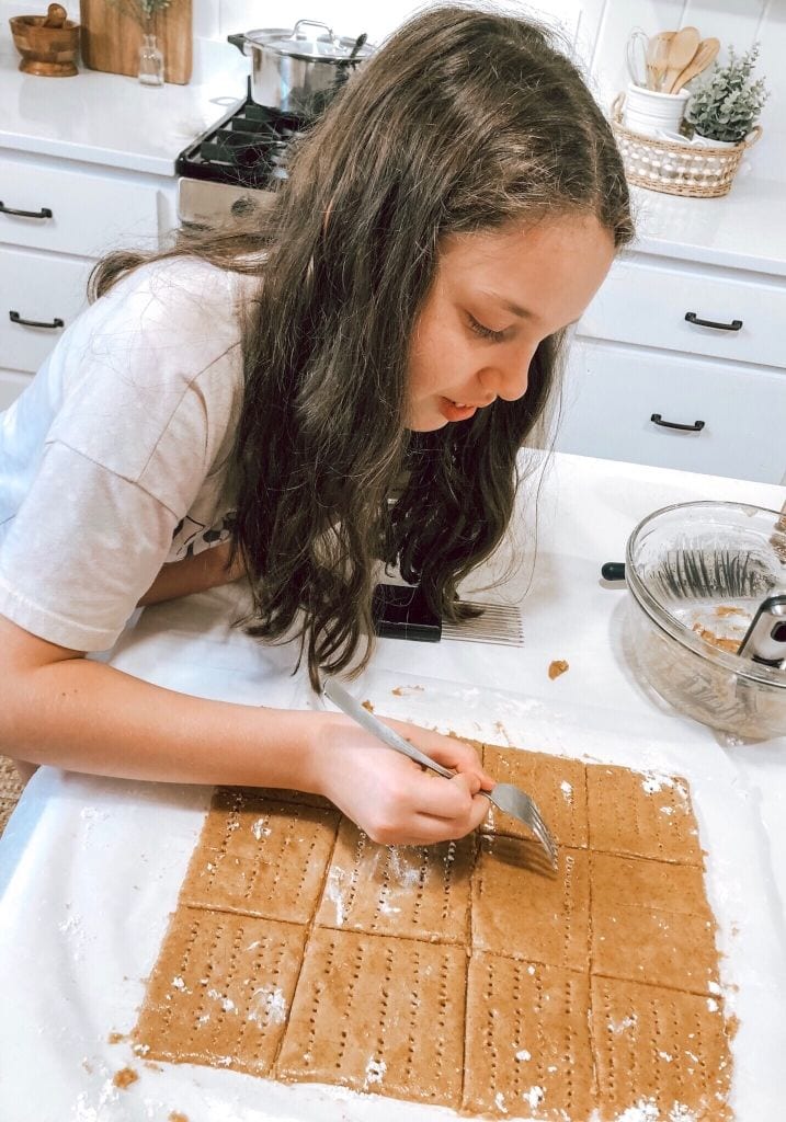 Close up of daughter making graham crackers