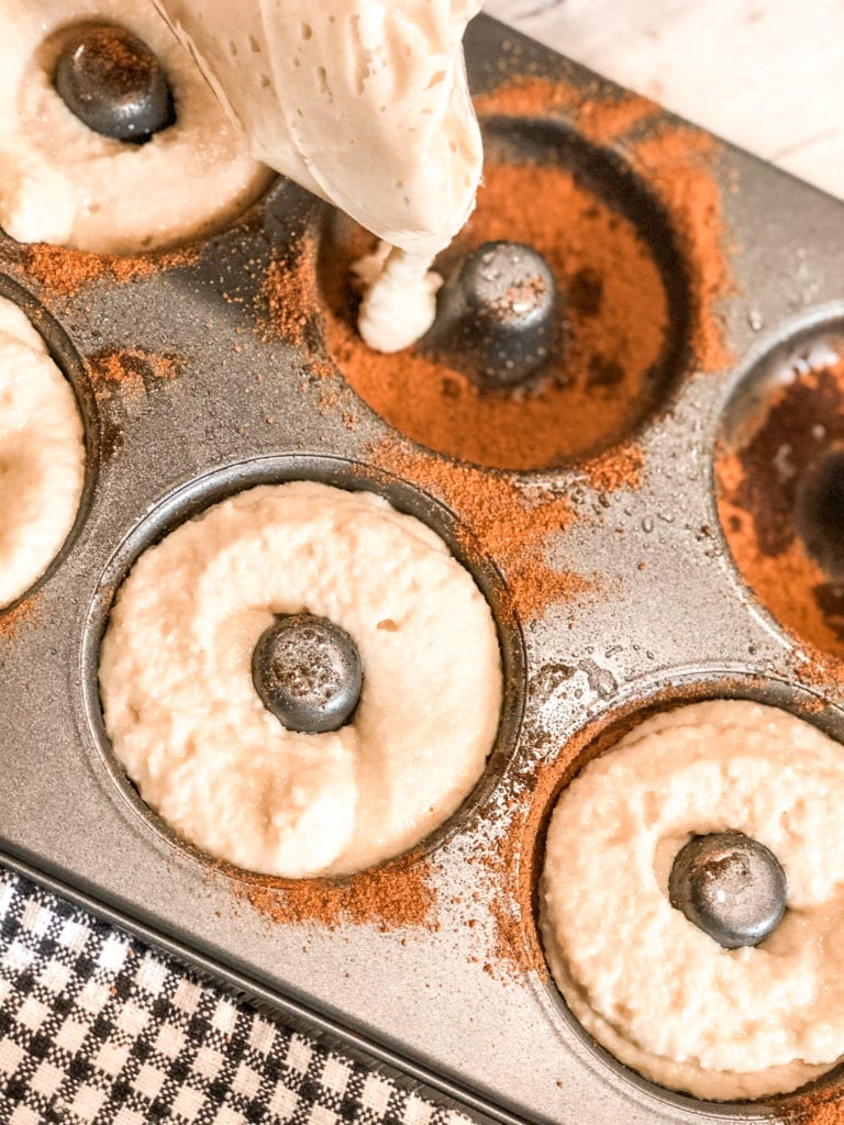 Close up of cinnamon sugar bagel batter in bagel pan.