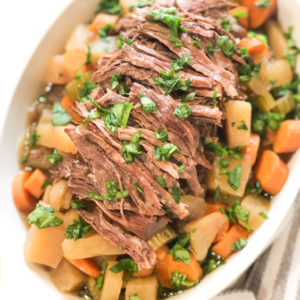 Close up of pot roast in a white dish
