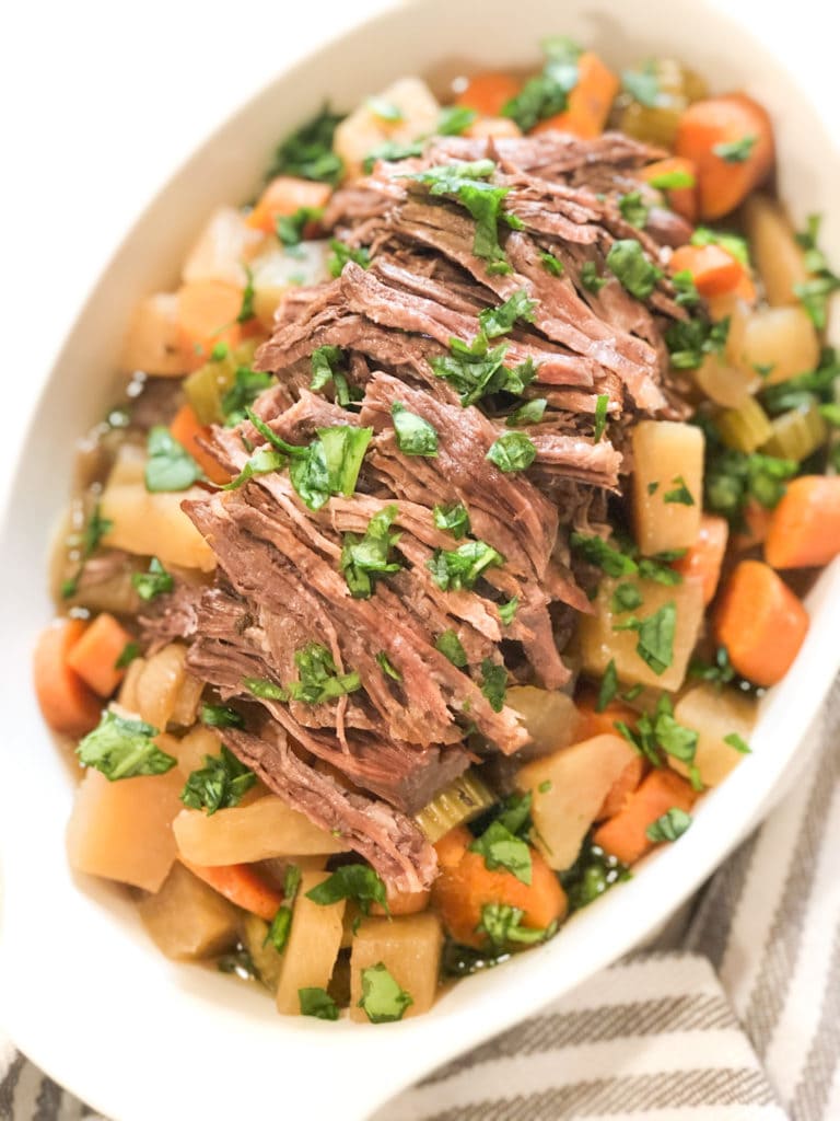 Close up of pot roast in a white dish