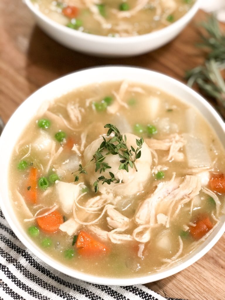 Close up of chicken pot pie soup in white bowl