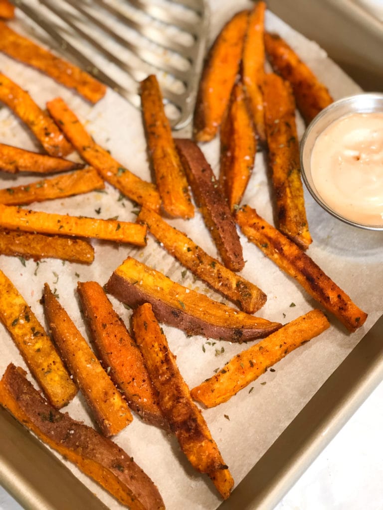 Close up of crispy sweet potato fries on sheet pan