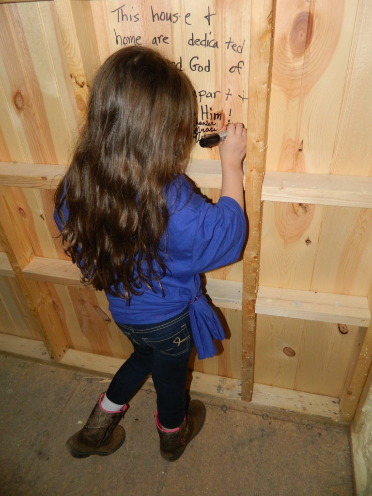Our youngest writing scripture and statements to Jesus in her bedroom.