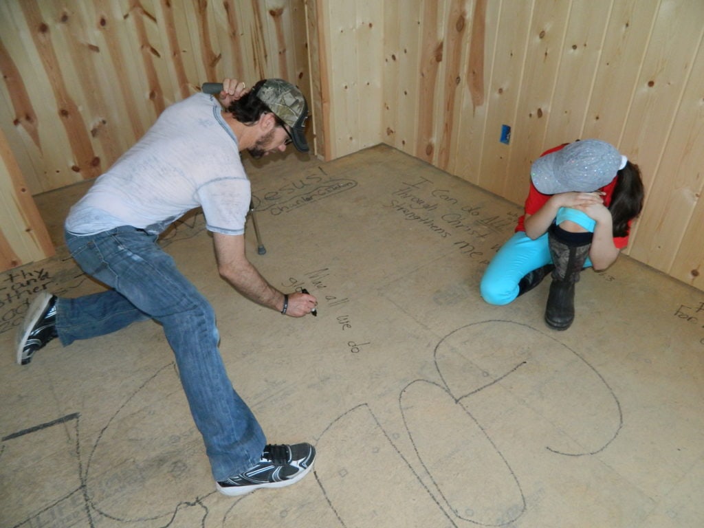 My husband and oldest daughter writing on her bedroom floor.