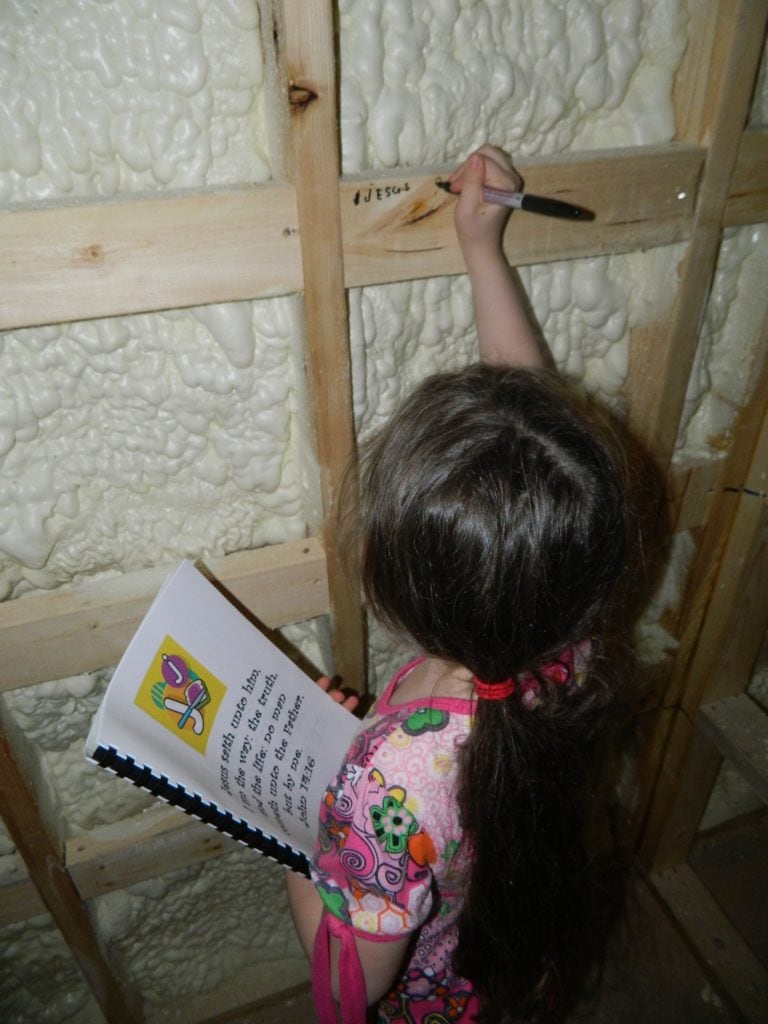 Our youngest writing scripture on her bedroom wall.