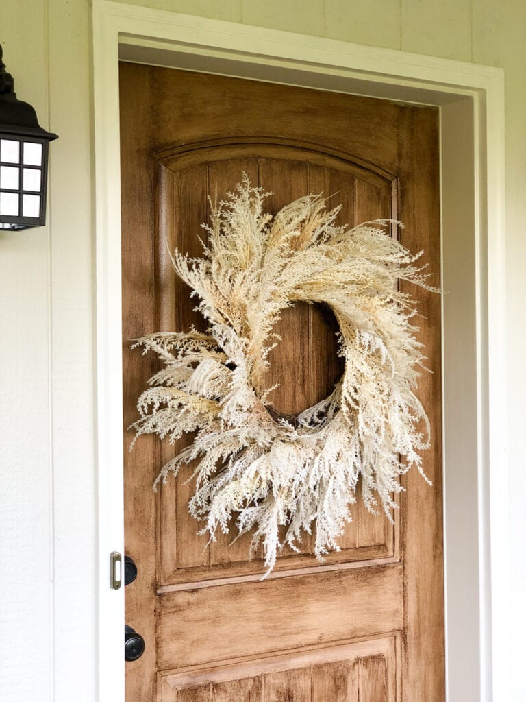Faux wood front door with wreath (close up)